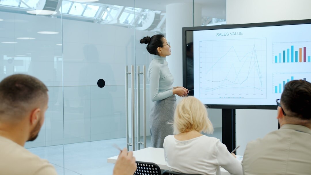 Woman presenting market data to colleagues